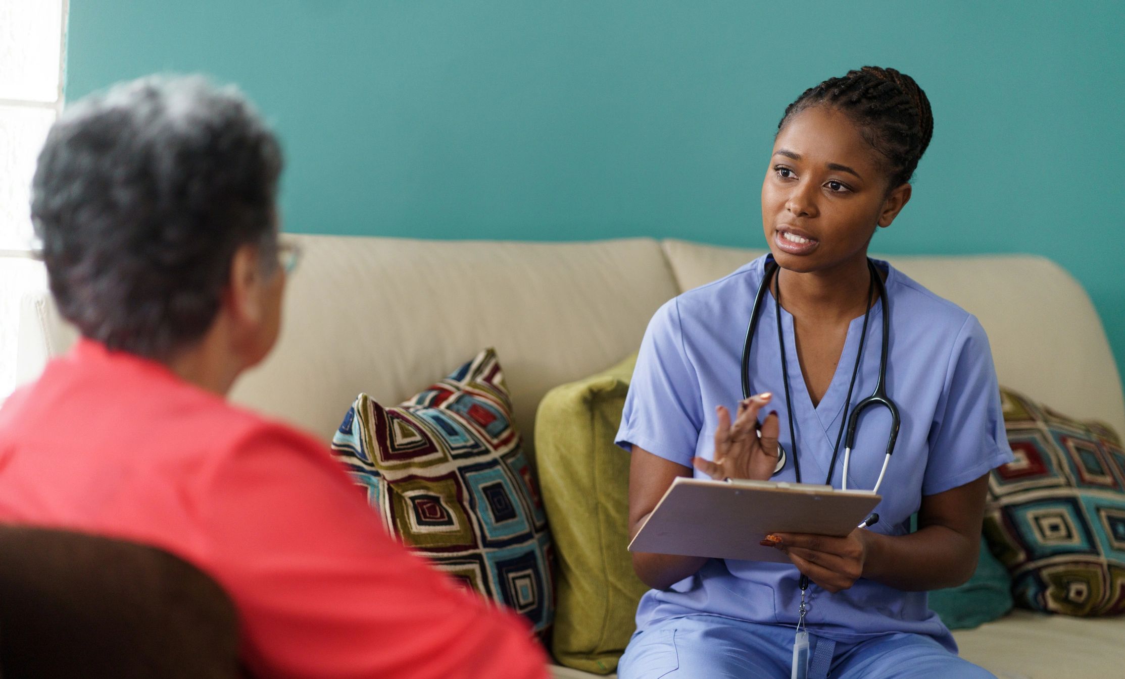Clinician using a tablet during an in-home healthcare visit