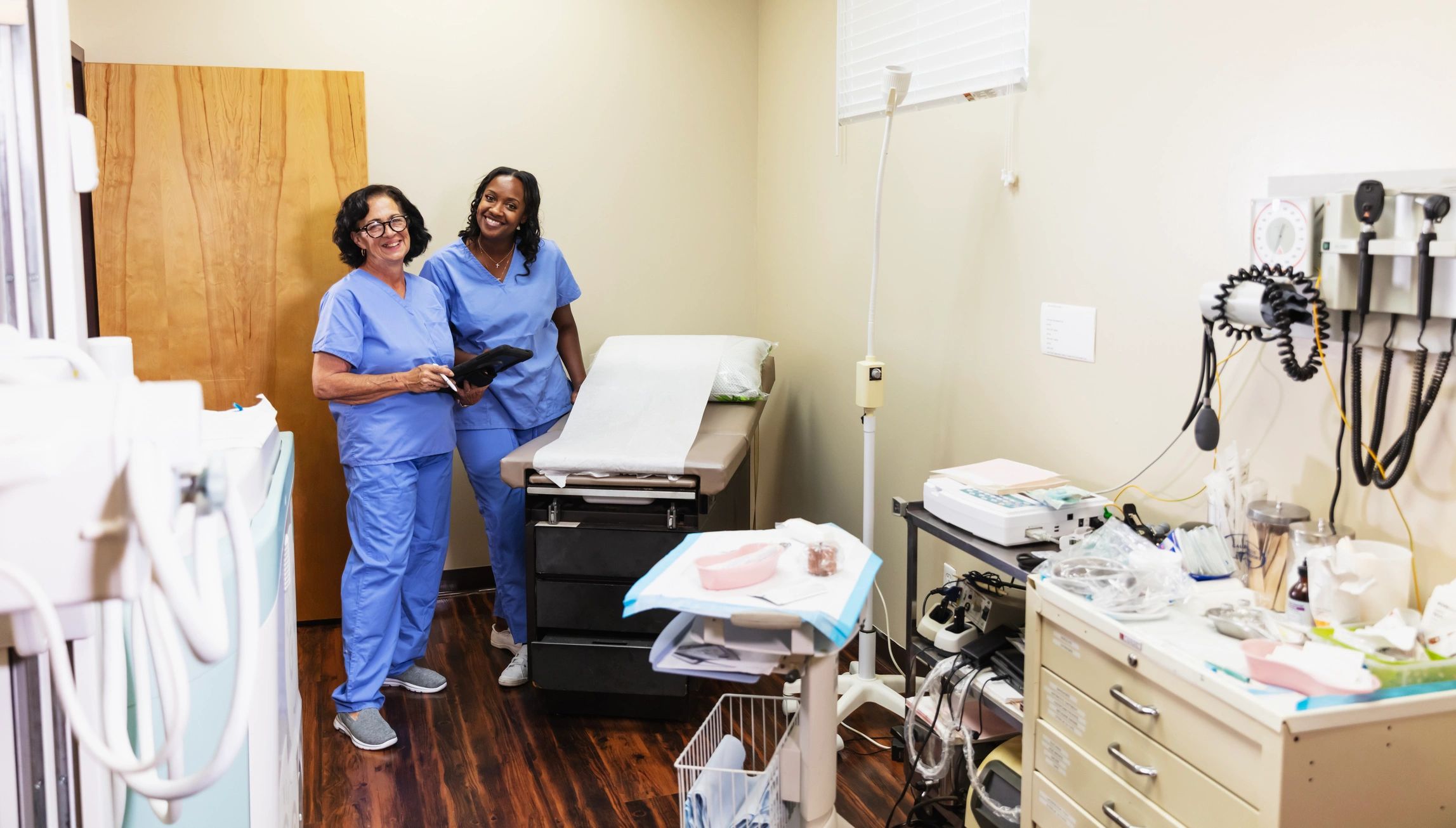 Healthcare team members standing together with a digital tablet