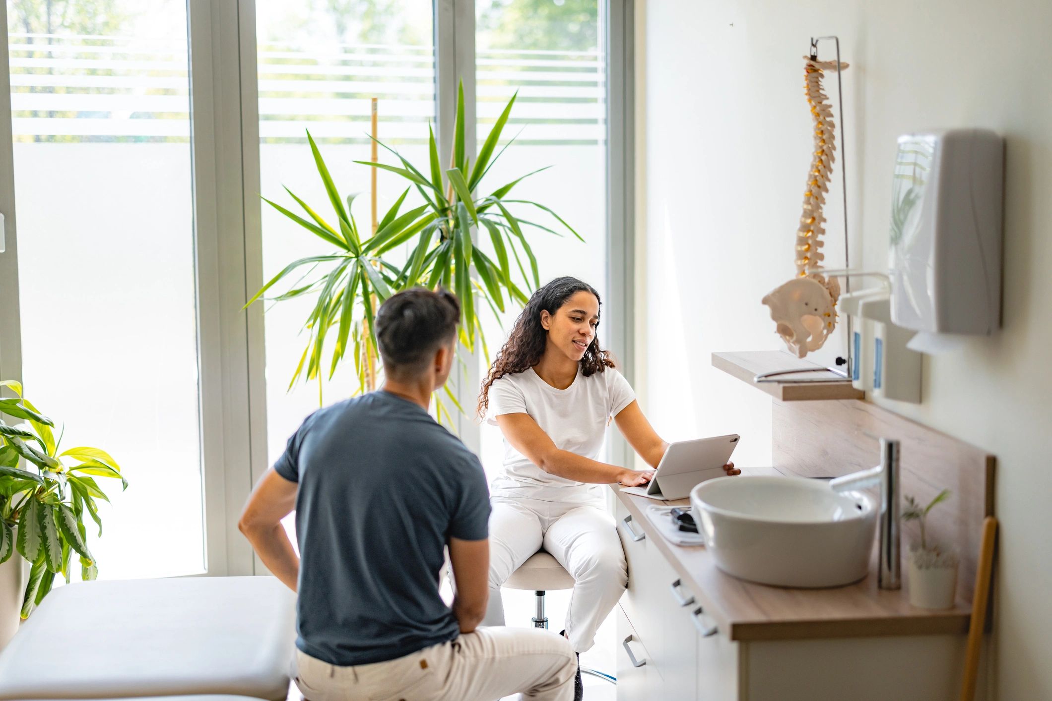 Healthcare professional reviewing care details with a patient during consultation